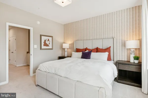 a bedroom with a bed and a lamp