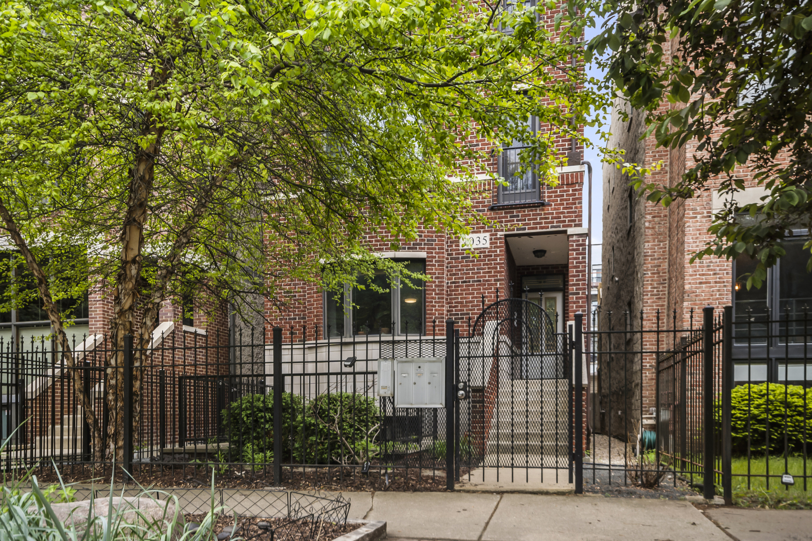 a front view of a house with tree s