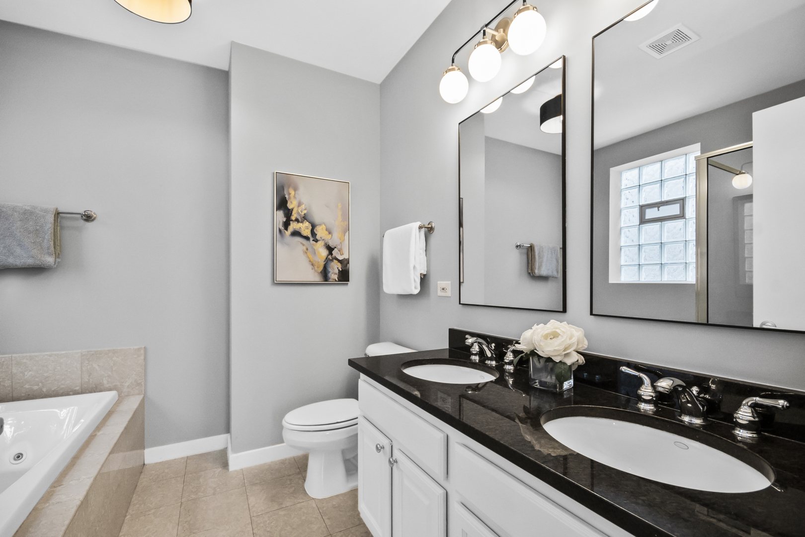 2035 West Crystal Street, Unit 3 Chicago, IL 60622 - Photo 14 of 18 a bathroom with a granite countertop sink toilet a large mirror a shower and a window