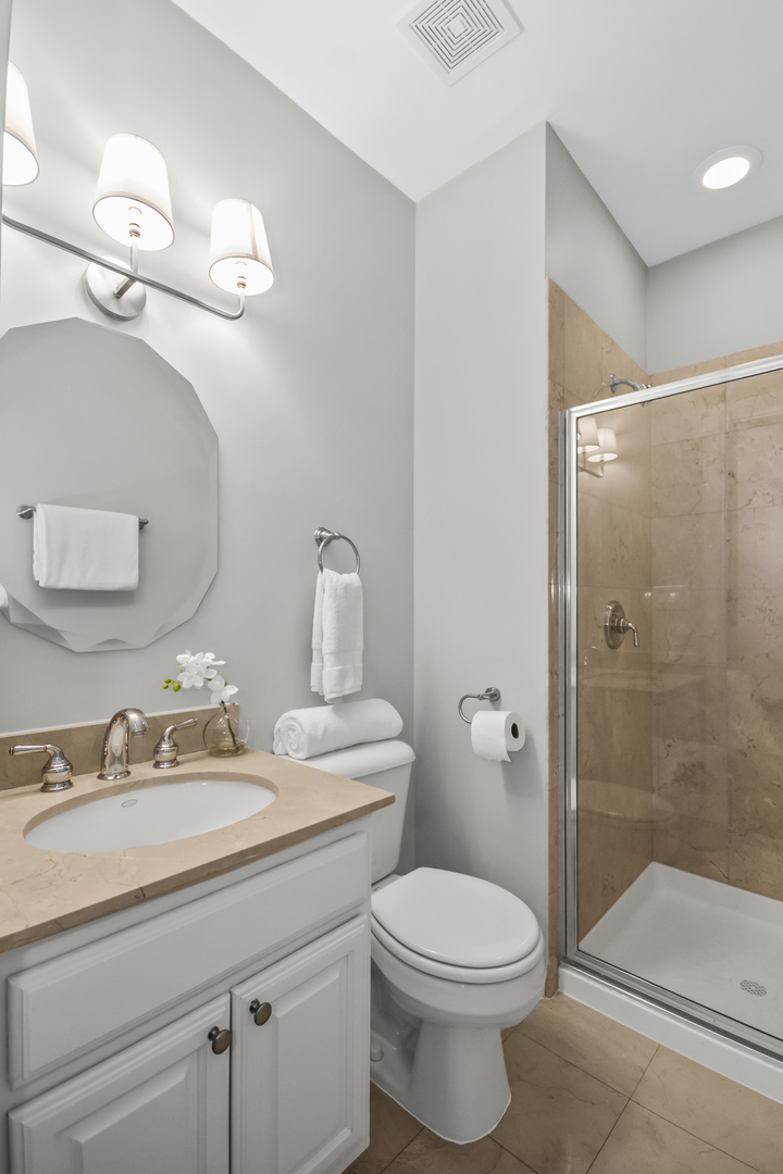 2035 West Crystal Street, Unit 3 Chicago, IL 60622 - Photo 17 of 18 a bathroom with a toilet a sink a mirror and shower