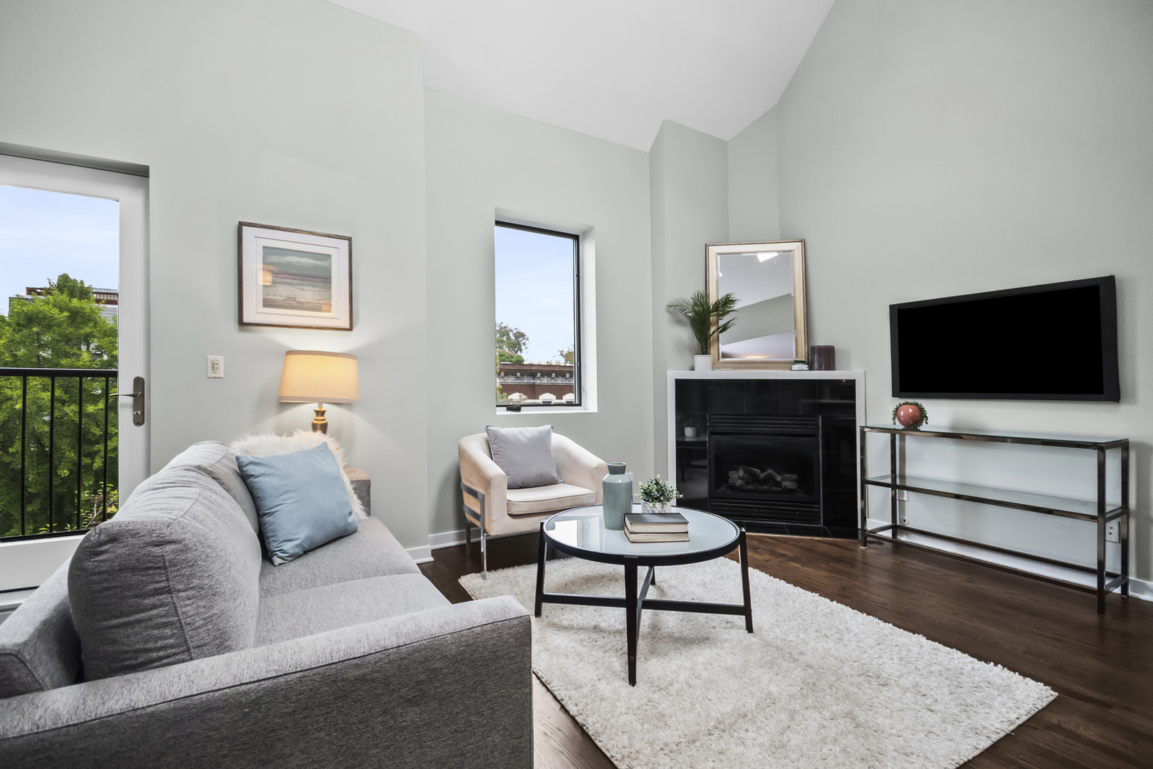 2035 West Crystal Street, Unit 3 Chicago, IL 60622 - Photo 2 of 18 a living room with furniture a flat screen tv and a fireplace