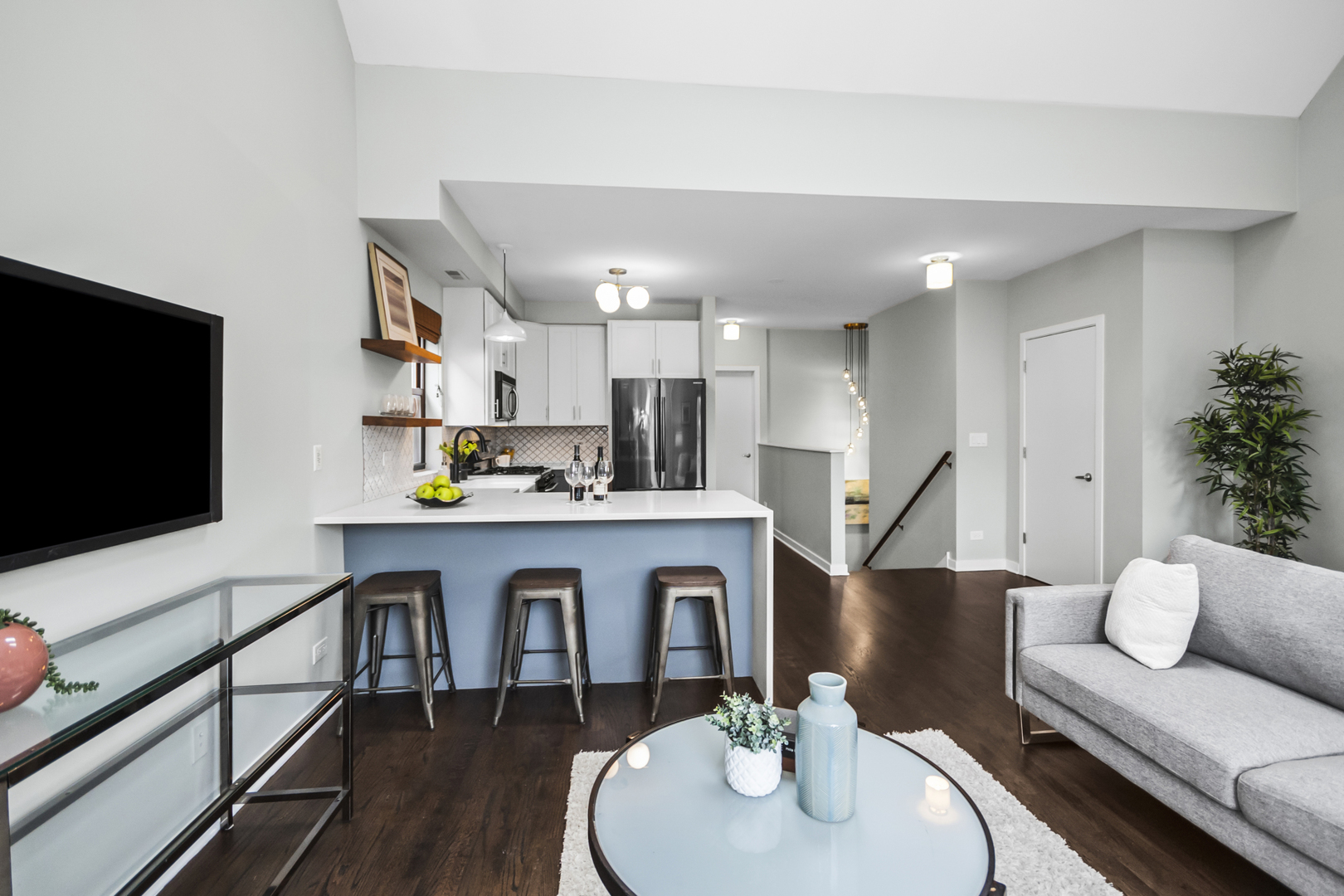 2035 West Crystal Street, Unit 3 Chicago, IL 60622 - Photo 6 of 18 a living room with kitchen island furniture and a flat screen tv