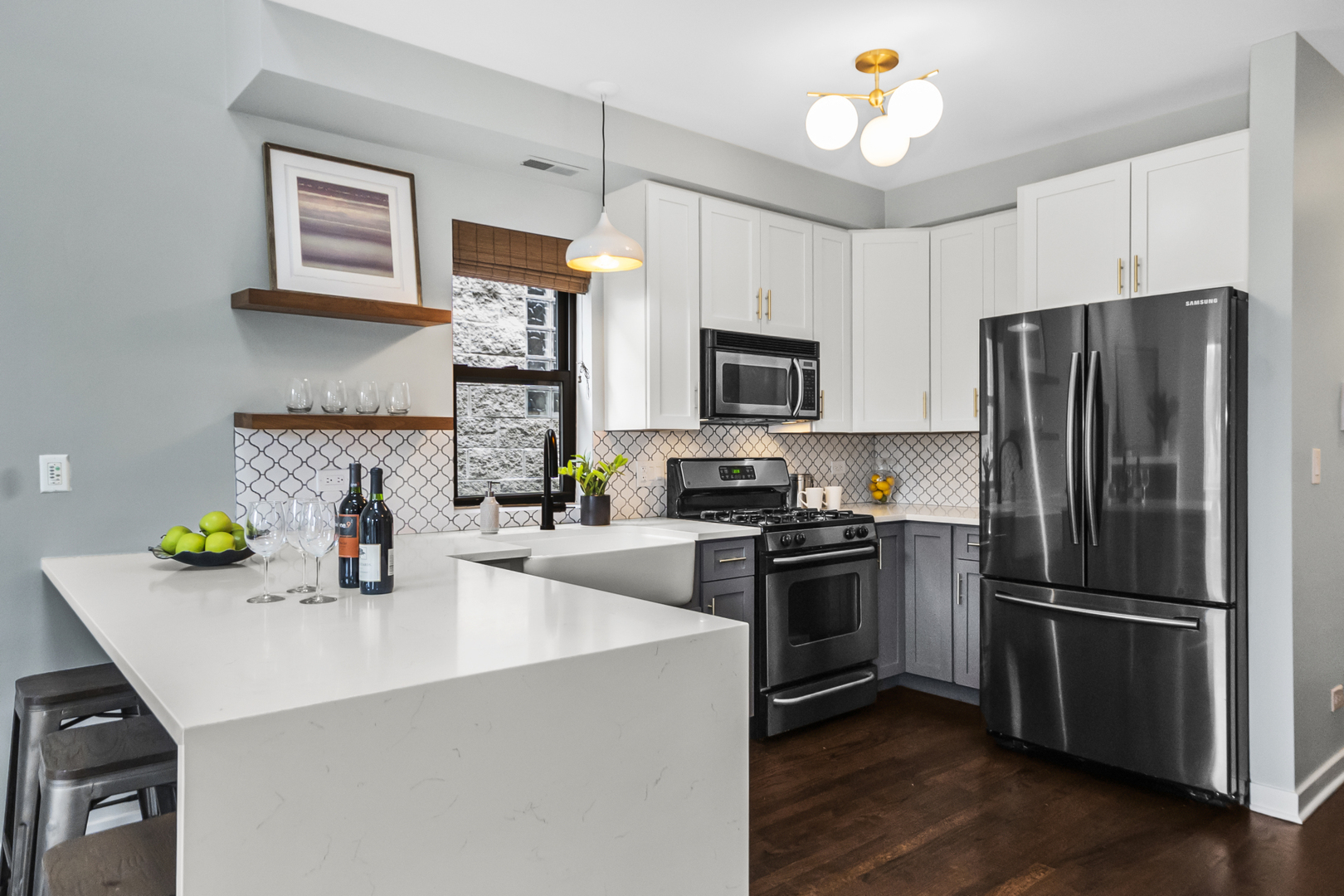 2035 West Crystal Street, Unit 3 Chicago, IL 60622 - Photo 8 of 18 a kitchen with a refrigerator a microwave a sink and wooden floor
