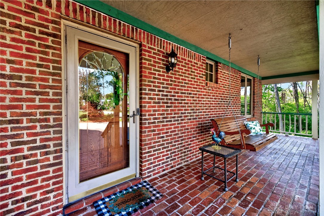330 South Alpha Bellbrook Road Bellbrook, OH 45305 - Photo 7 of 87 Embrace outdoor living on this inviting brick porch, perfect for relaxation.