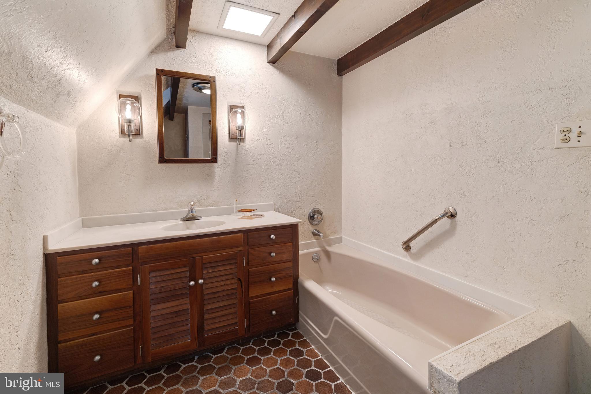 1356 Barrowdale Road Jenkintown, PA 19046 - Photo 18 of 35 a bathroom with a tub sink and mirror