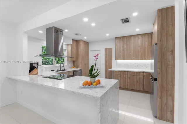 a kitchen with a sink stove top oven and cabinets
