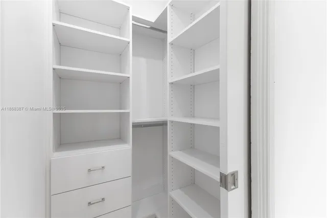 a view of walk in closet with empty racks