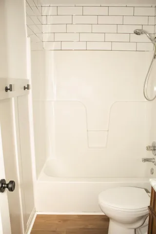 a bathroom with a toilet and a shower