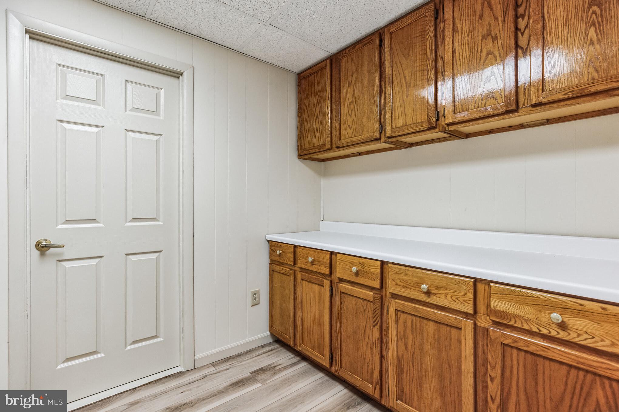11425 Mill Bridge Road Lusby, MD 20657 - Photo 21 of 40 a view of a kitchen with wooden cabinets