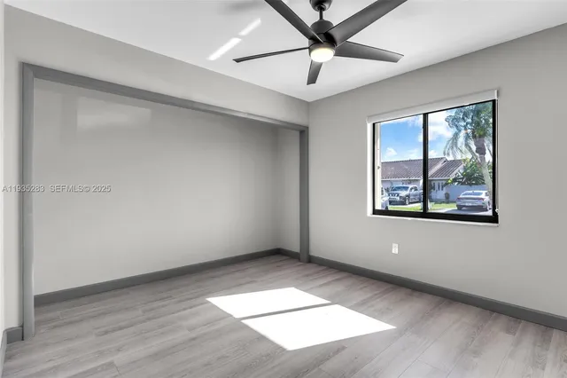 wooden floor in an empty room with a window