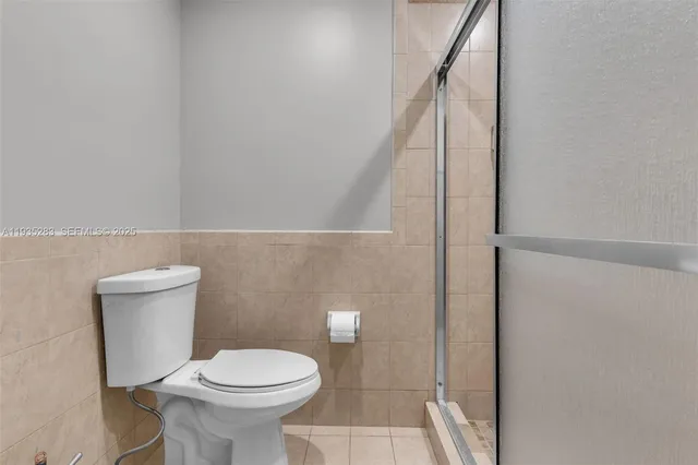 a white toilet sitting next to a bathroom sink