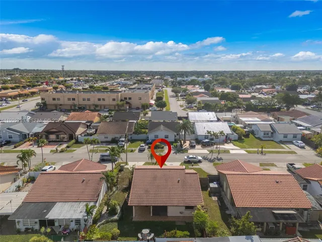 an aerial view of residential houses with outdoor space
