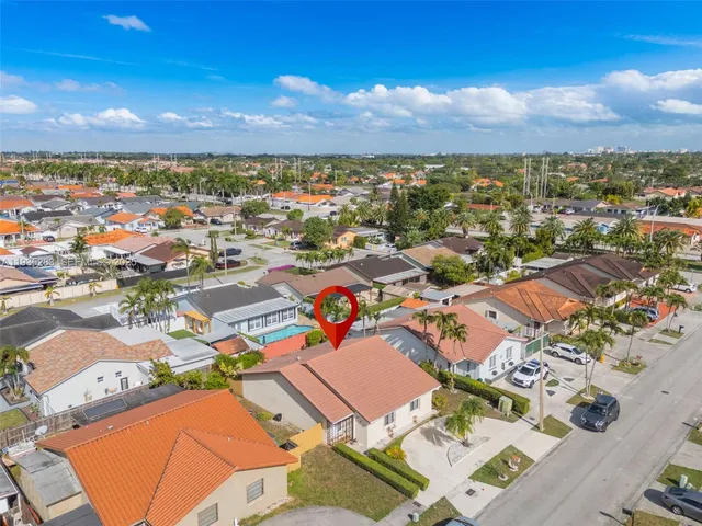 an aerial view of residential houses with outdoor space