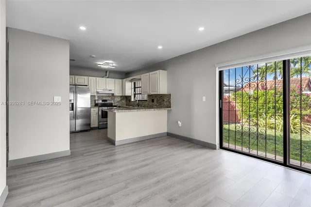a view of kitchen with wooden floor