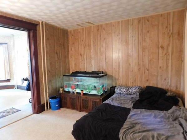714 North Main Street Rochelle, IL 61068 - Photo 7 of 15 a bed sitting in a bedroom next to a window