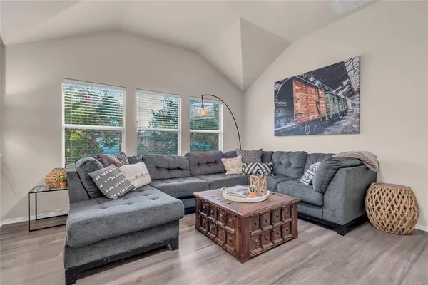 a living room with furniture and a large window