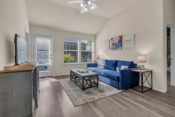 a living room with furniture and a flat screen tv
