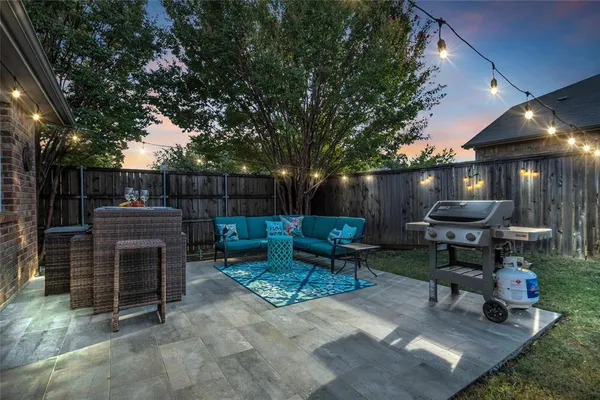a view of a backyard with furniture and a fire pit