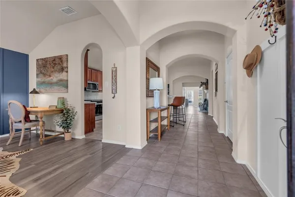 a living room with furniture a dining table and chairs with wooden floor