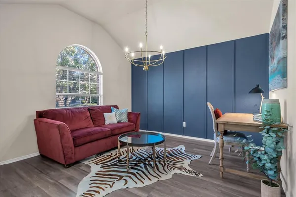 a living room with furniture a window and a chandelier