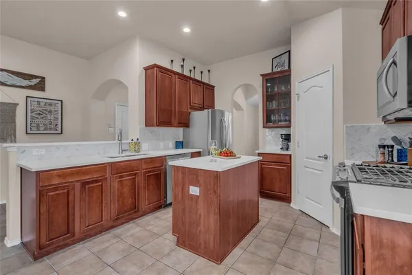 a kitchen with stainless steel appliances granite countertop a sink counter space and cabinets
