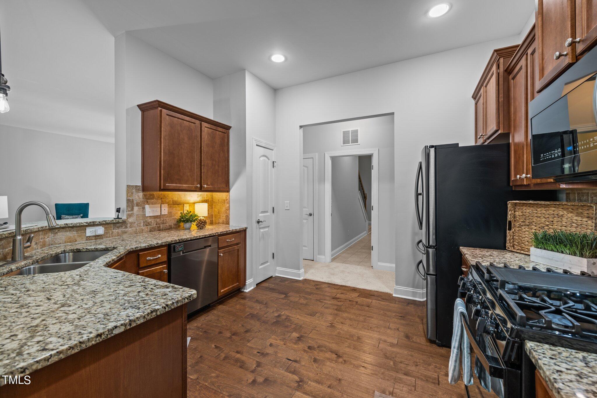 95 Windy Creek Drive Willow Spring, NC 27592 - Photo 14 of 55 a kitchen with stainless steel appliances granite countertop a refrigerator and a stove top oven
