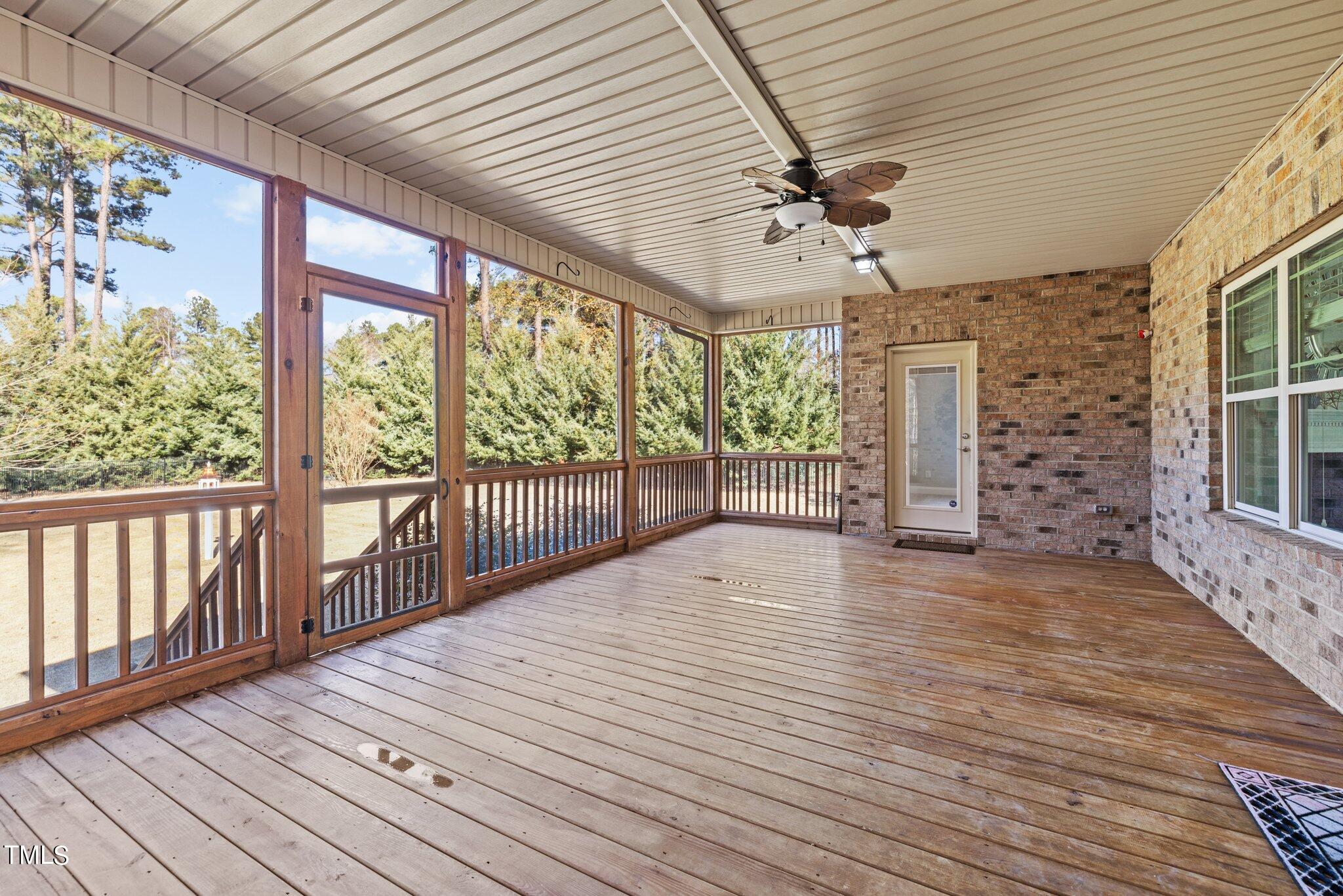 95 Windy Creek Drive Willow Spring, NC 27592 - Photo 18 of 55 a view of a patio with wooden floor and iron stairs