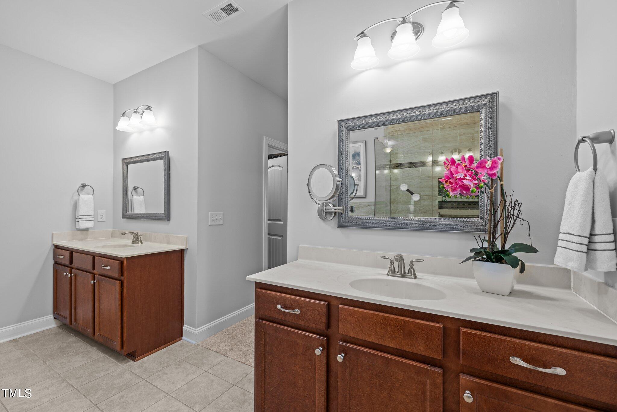 95 Windy Creek Drive Willow Spring, NC 27592 - Photo 22 of 55 a bathroom with a sink and a mirror