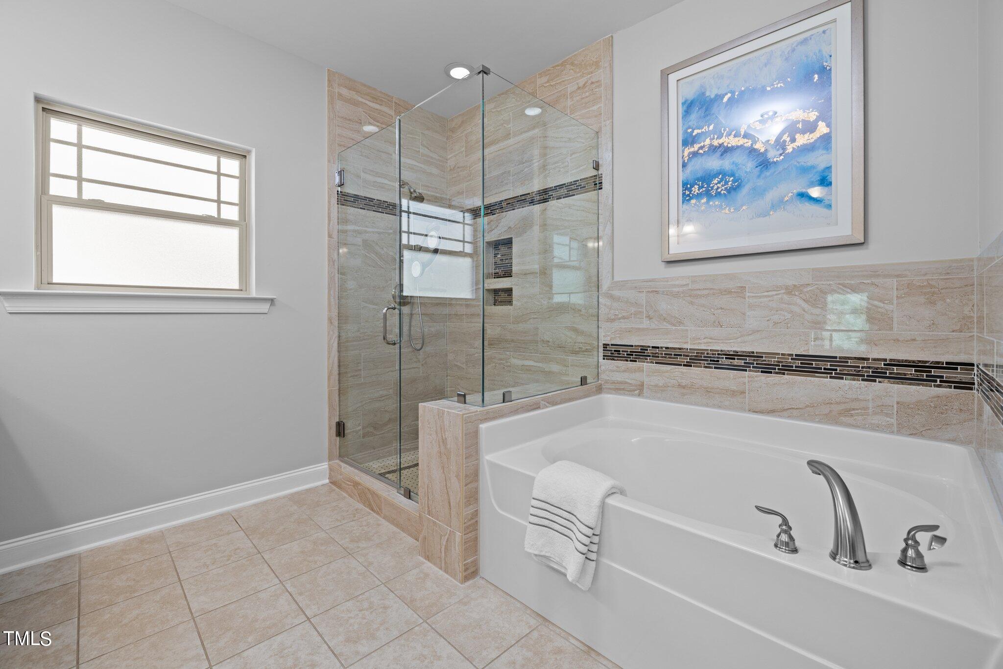 95 Windy Creek Drive Willow Spring, NC 27592 - Photo 23 of 55 a spacious bathroom with a tub and a shower