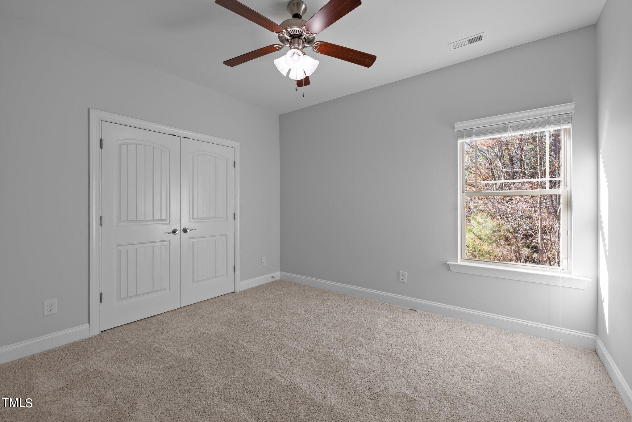 95 Windy Creek Drive Willow Spring, NC 27592 - Photo 24 of 55 a view of an empty room with a window