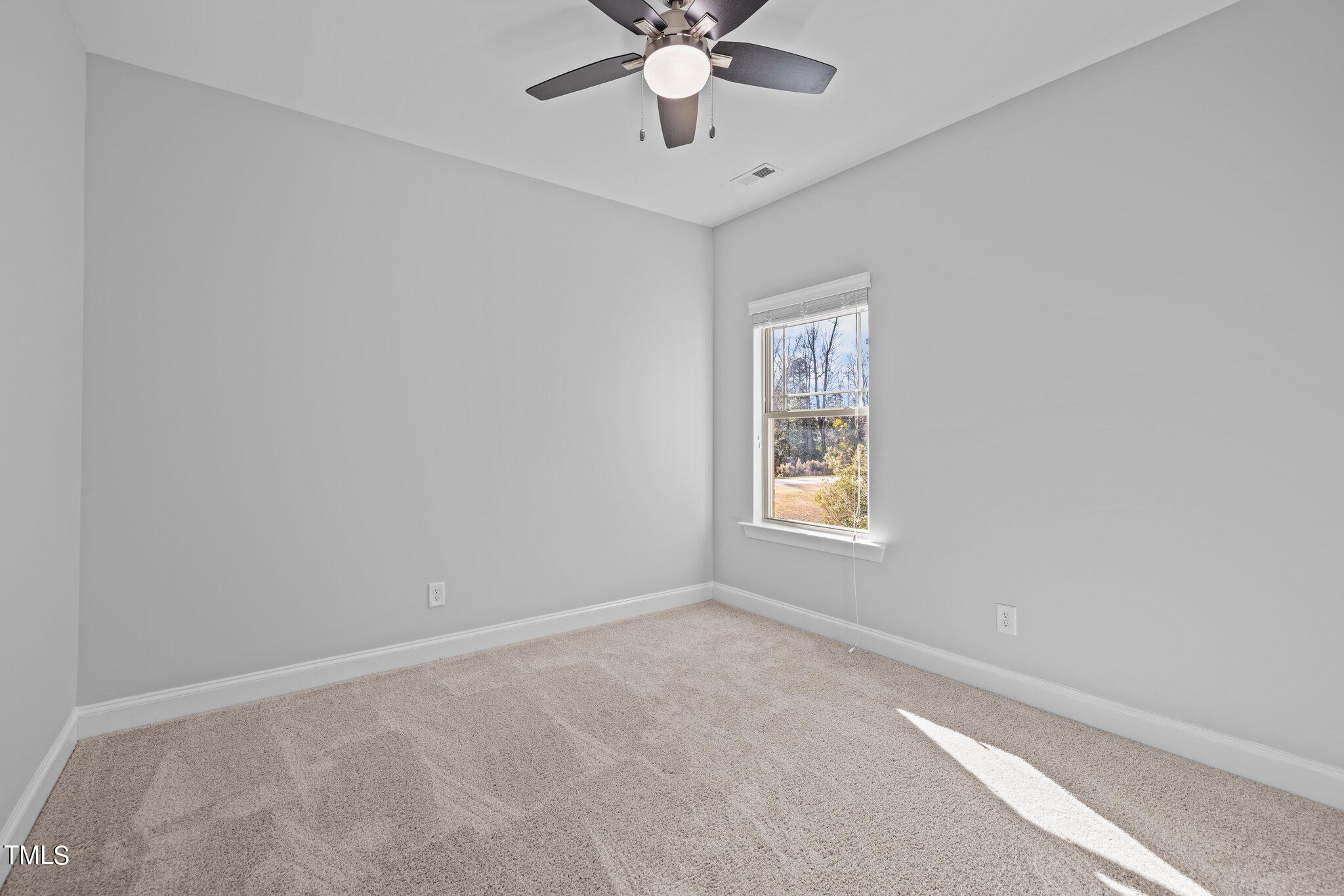 95 Windy Creek Drive Willow Spring, NC 27592 - Photo 26 of 55 a view of an empty room with a window