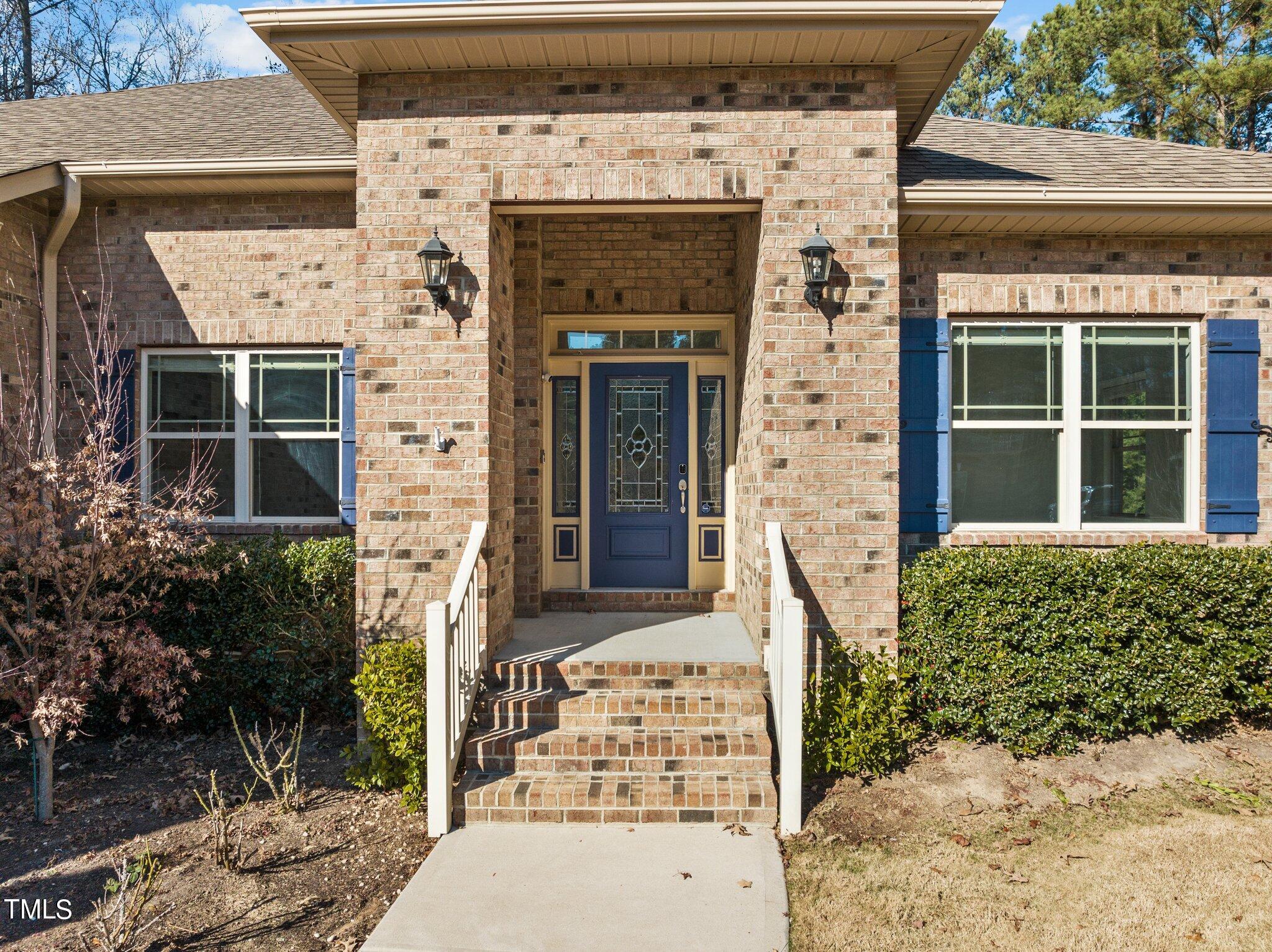 95 Windy Creek Drive Willow Spring, NC 27592 - Photo 3 of 55 front view of a house with potted plants