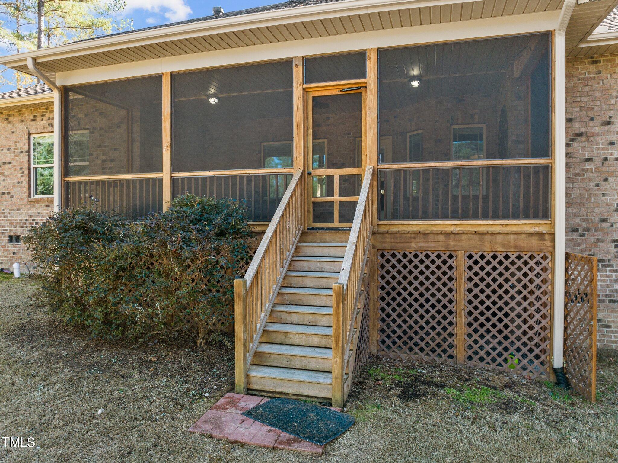 95 Windy Creek Drive Willow Spring, NC 27592 - Photo 42 of 55 a view of a house with a large window and wooden fence