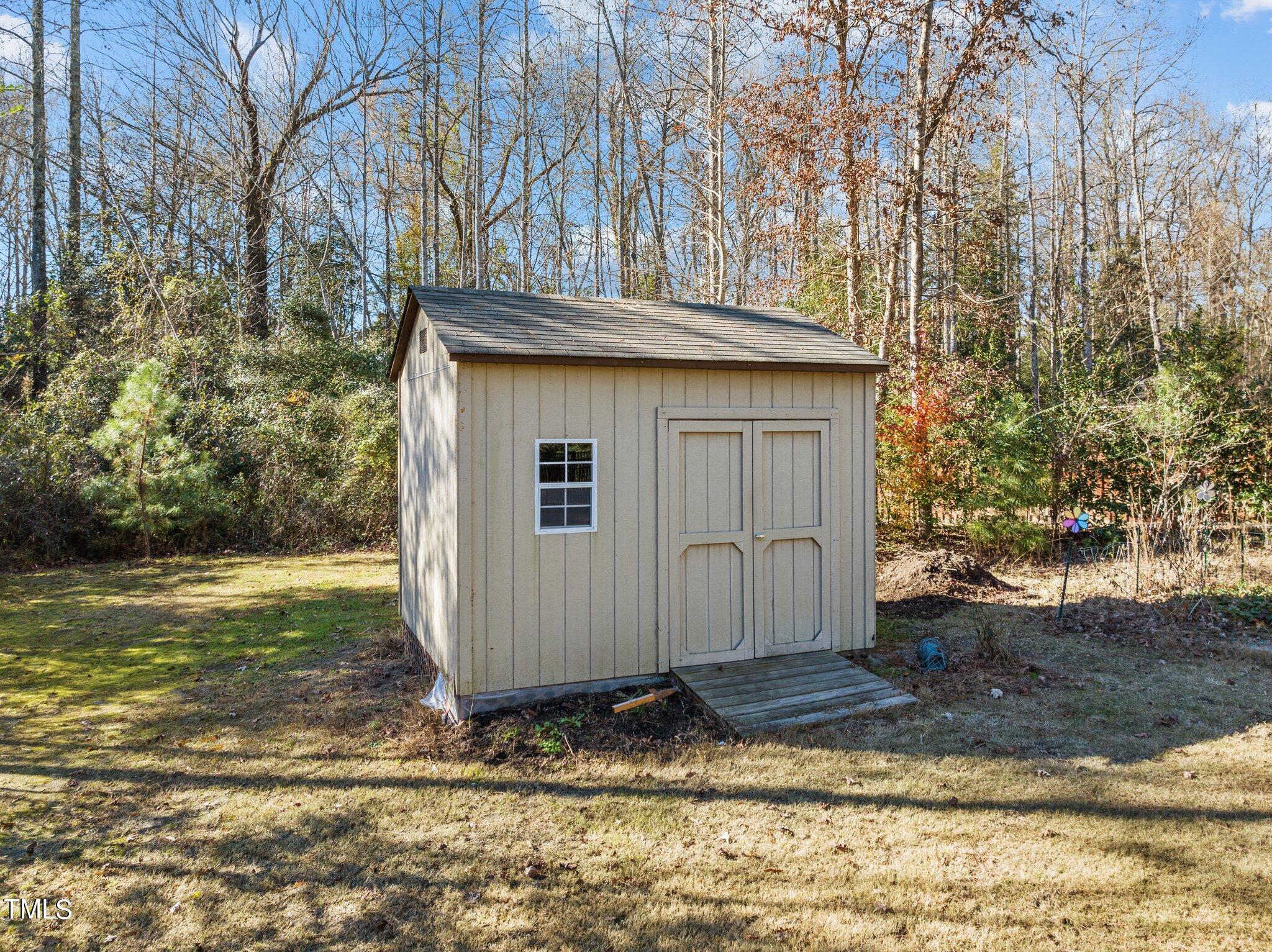 95 Windy Creek Drive Willow Spring, NC 27592 - Photo 47 of 55 a wooden house with trees in the background