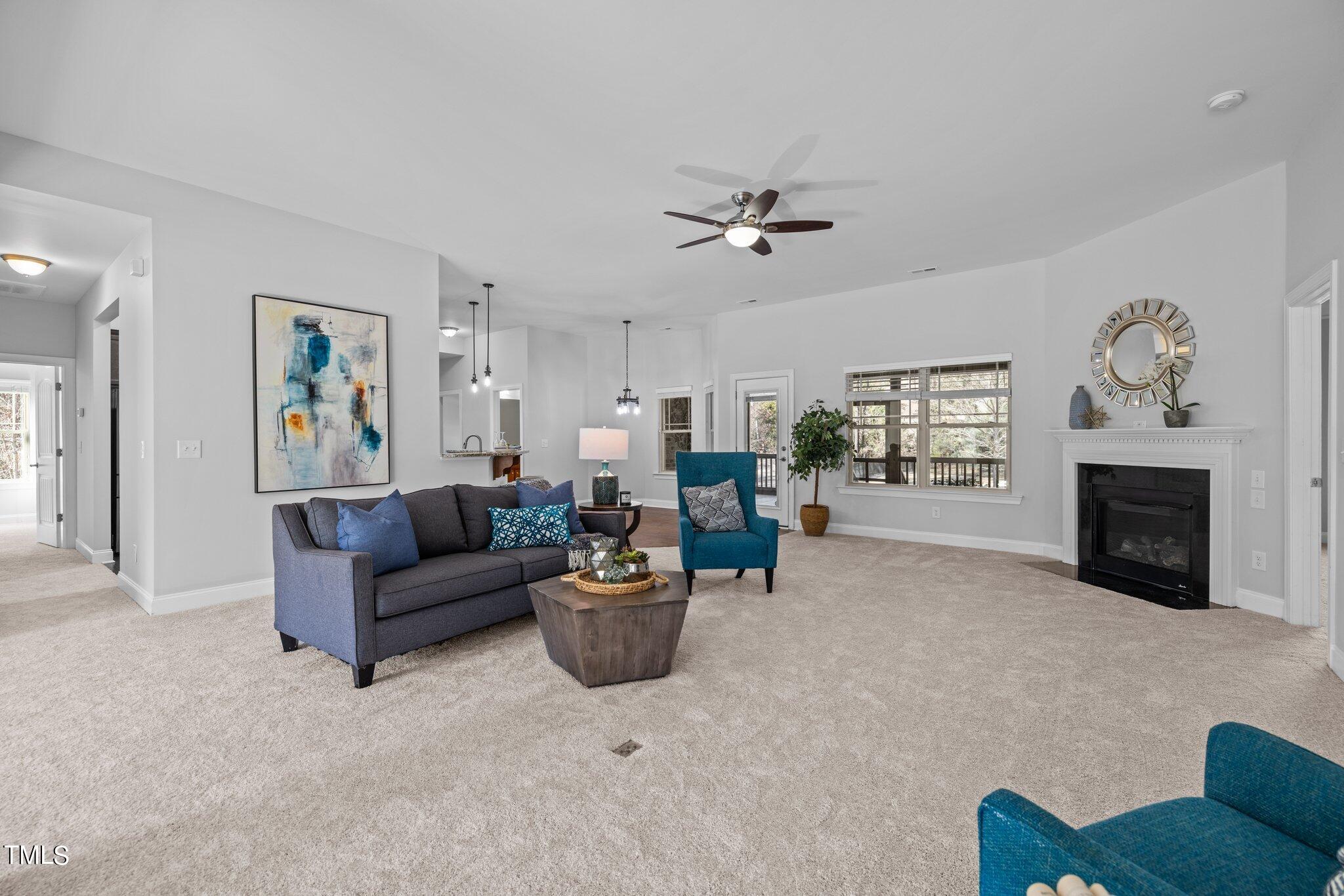 95 Windy Creek Drive Willow Spring, NC 27592 - Photo 10 of 55 a living room with furniture a fireplace and a window