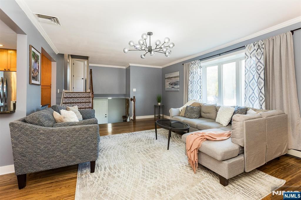 179 Grove Avenue Verona, NJ 07044 - Photo 11 of 34 a living room with furniture and a chandelier