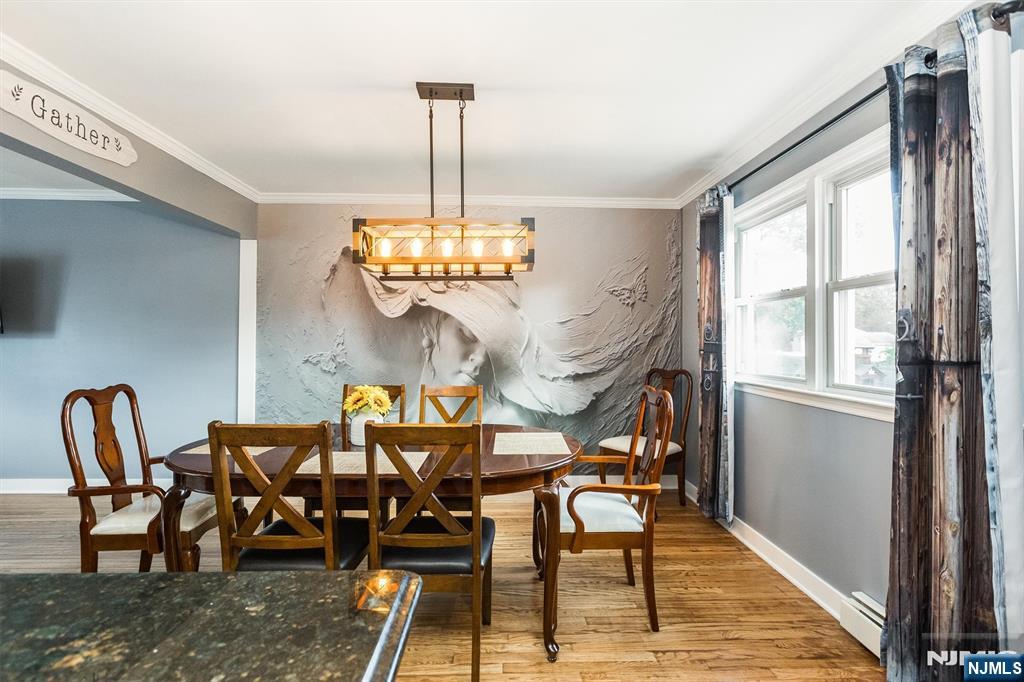179 Grove Avenue Verona, NJ 07044 - Photo 15 of 34 a view of a dining room with furniture a chandelier and wooden floor