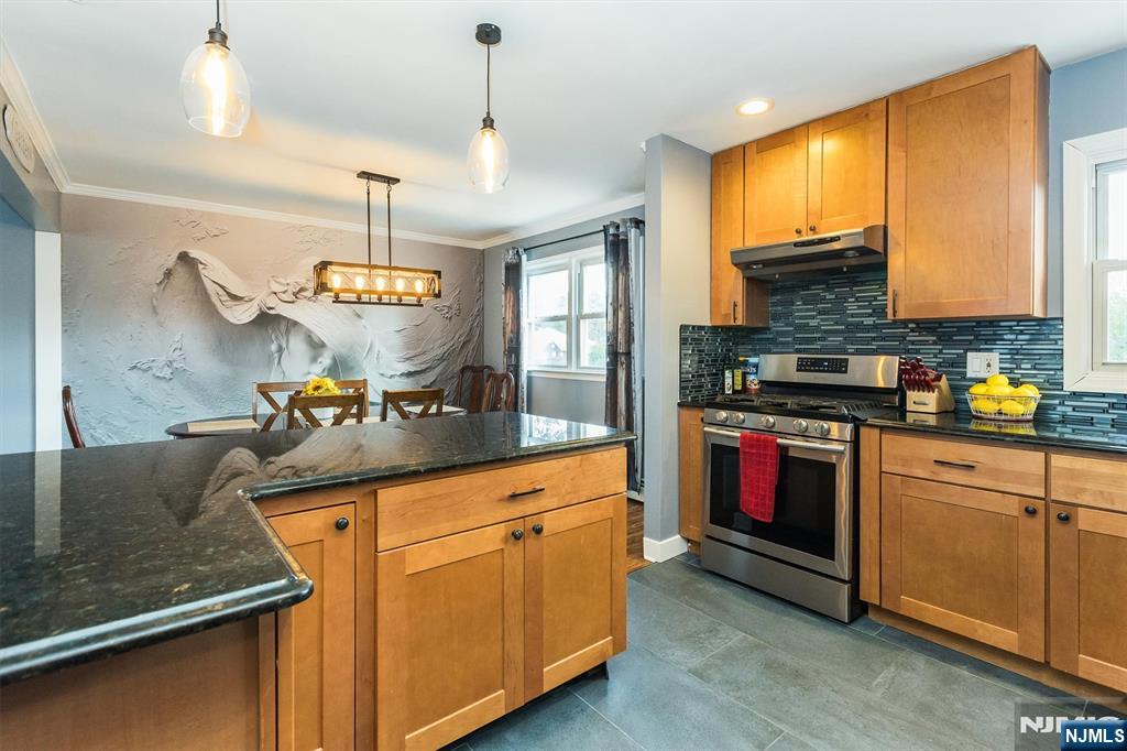 179 Grove Avenue Verona, NJ 07044 - Photo 17 of 34 a kitchen with stainless steel appliances granite countertop a sink a stove and a refrigerator