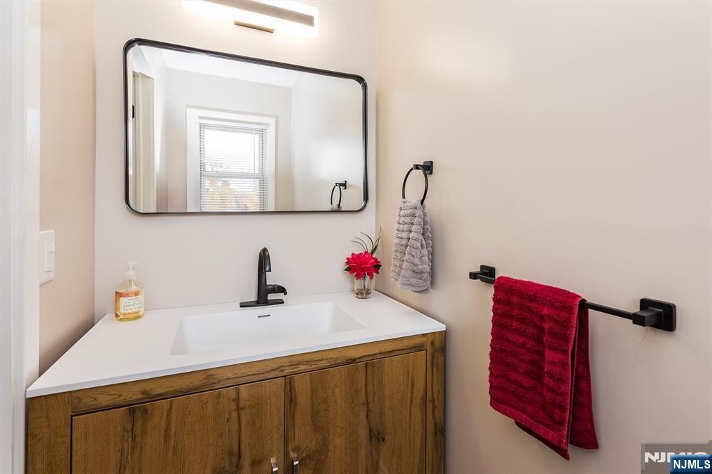 179 Grove Avenue Verona, NJ 07044 - Photo 22 of 34 a bathroom with a sink and a mirror