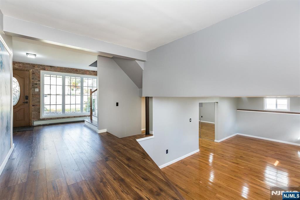 179 Grove Avenue Verona, NJ 07044 - Photo 26 of 34 an empty room with wooden floor and windows