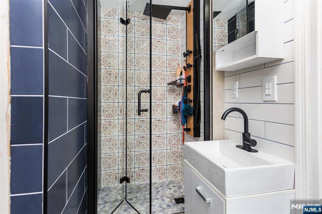 179 Grove Avenue Verona, NJ 07044 - Photo 30 of 34 a bathroom with a sink and mirror