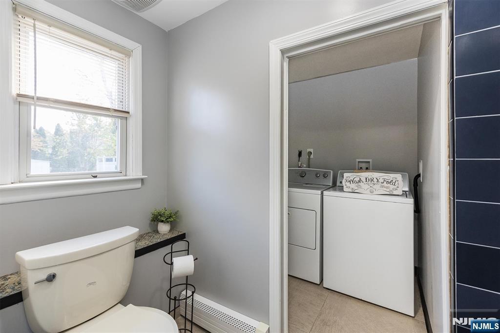 179 Grove Avenue Verona, NJ 07044 - Photo 31 of 34 a bathroom with a toilet sink and window