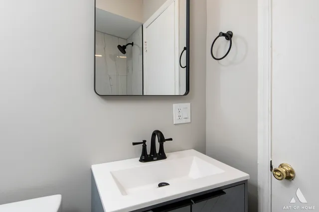 a bathroom with a sink and a mirror