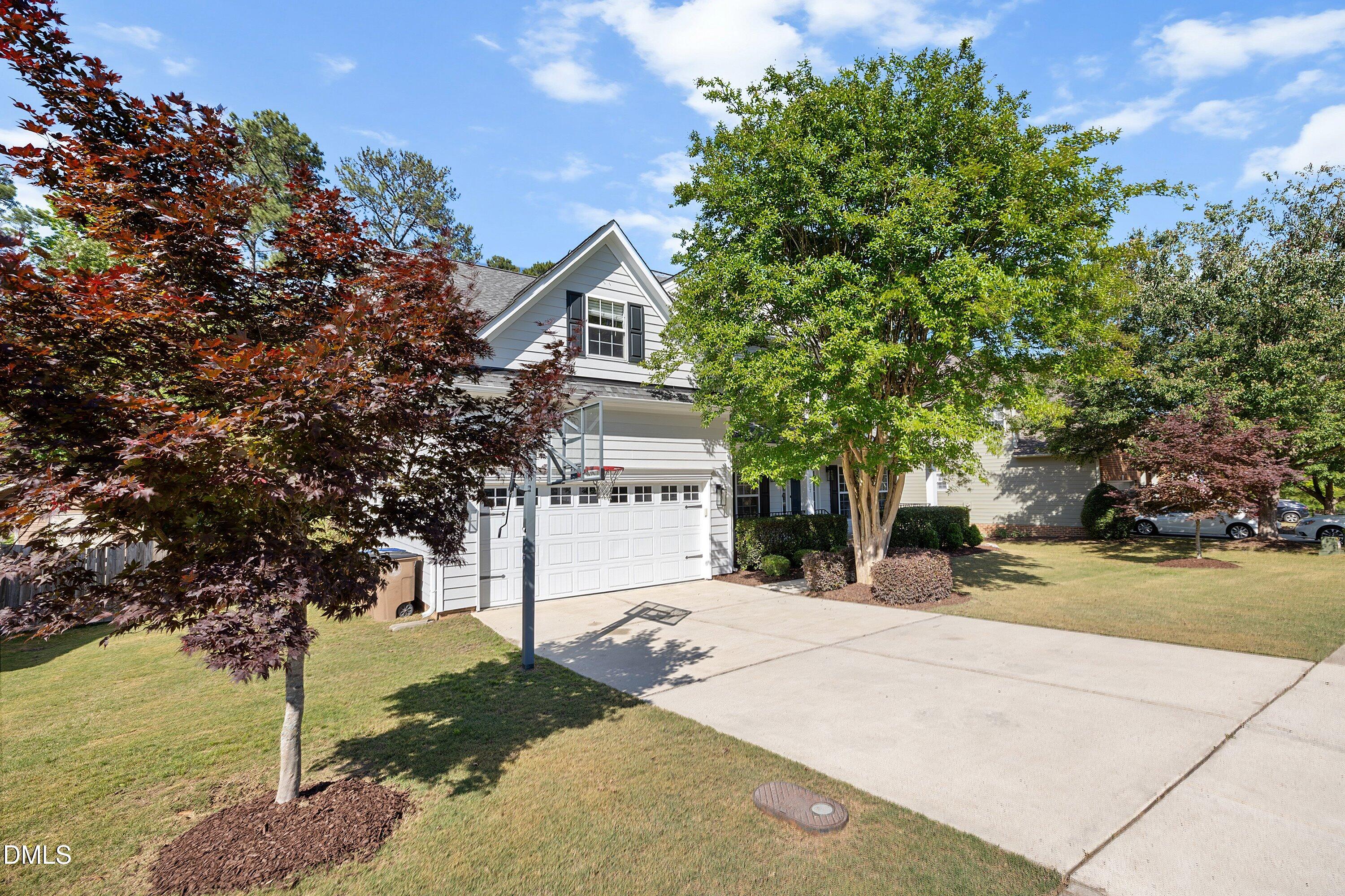 3717 Windmeade Road Wake Forest, NC 27587 - Photo 5 of 51 a view of a white house with a tree