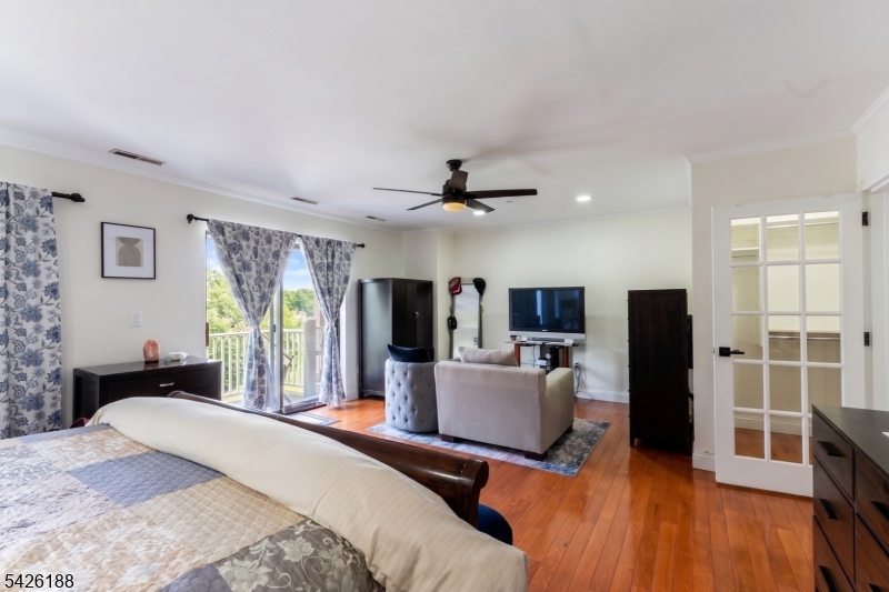 4 Millay Court Teaneck, NJ 07666 - Photo 11 of 32 a bedroom with a bed window and a television