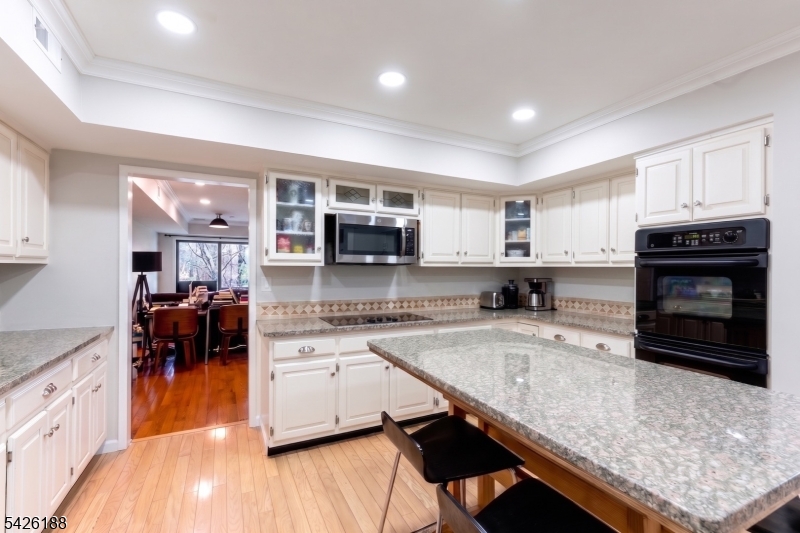 4 Millay Court Teaneck, NJ 07666 - Photo 13 of 32 a kitchen with a stove a sink and a microwave