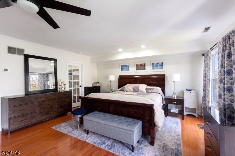 4 Millay Court Teaneck, NJ 07666 - Photo 19 of 32 a bedroom with a bed and wooden floor