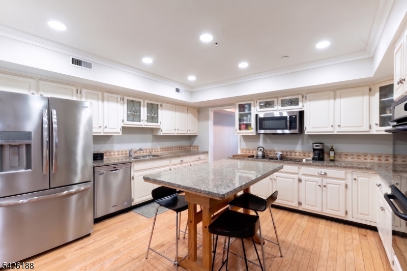4 Millay Court Teaneck, NJ 07666 - Photo 21 of 32 a kitchen with appliances a sink and cabinets