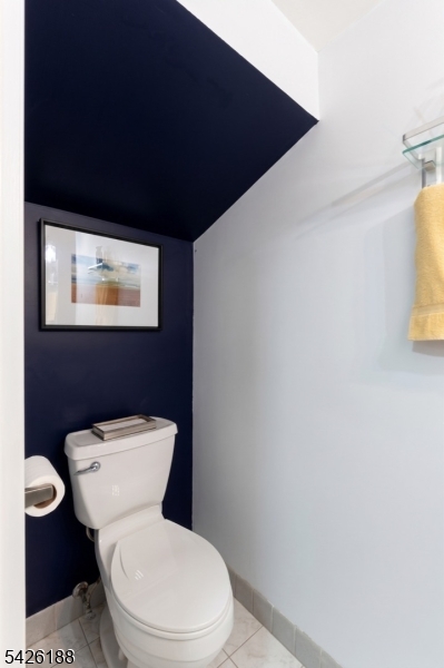 4 Millay Court Teaneck, NJ 07666 - Photo 22 of 32 a white toilet sitting next to a shower curtain