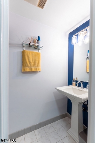 4 Millay Court Teaneck, NJ 07666 - Photo 24 of 32 a bathroom with a sink and a mirror